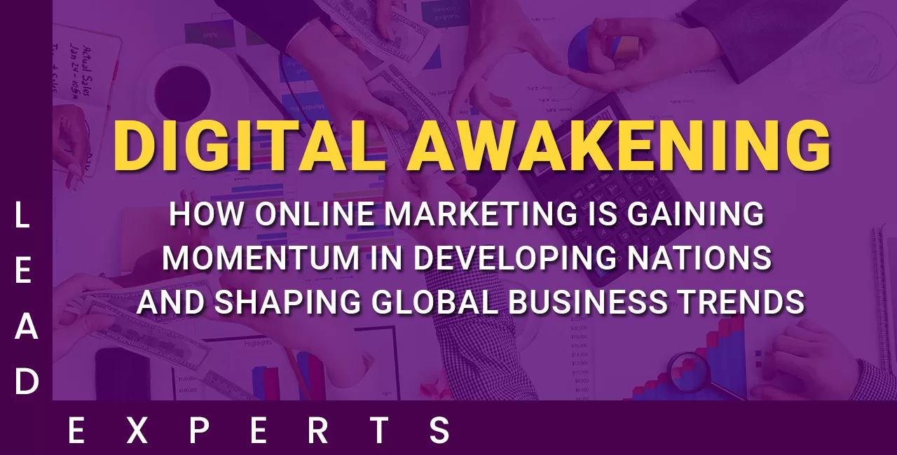 Hands working on laptops and charts with the text “DIGITAL AWAKENING: How online marketing is gaining momentum in developing nations and shaping global business trends.”. - Lead Experts