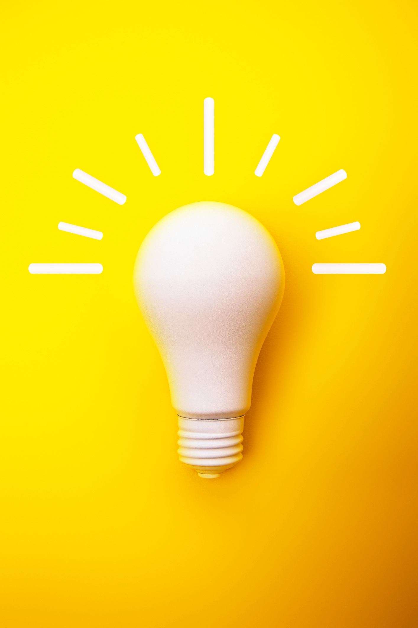 A white light bulb is centered on a bright yellow background, with white lines radiating from it to represent light or the concept of a new idea or inspiration. - Lead Experts